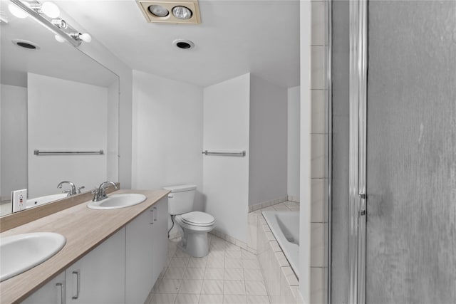 bathroom featuring double vanity, a sink, toilet, and a shower with door