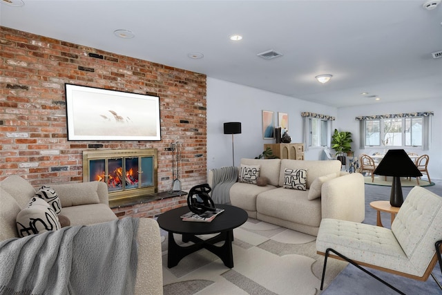 living area featuring a brick fireplace and visible vents