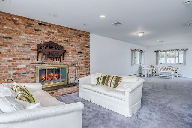 carpeted living room featuring a fireplace and visible vents