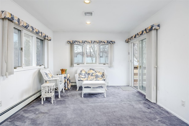 sitting room featuring a healthy amount of sunlight, carpet floors, a baseboard radiator, and visible vents