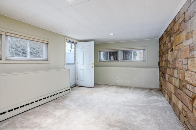 spare room featuring a baseboard heating unit, recessed lighting, and carpet floors