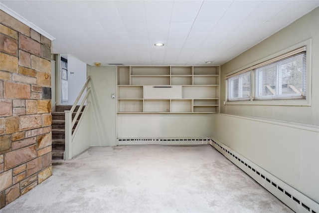 basement with a baseboard radiator, recessed lighting, a baseboard heating unit, stairs, and carpet