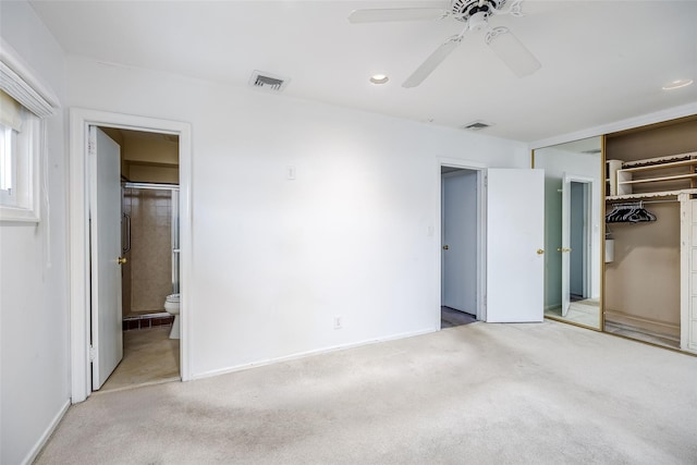 unfurnished bedroom featuring carpet, visible vents, a closet, and ensuite bathroom