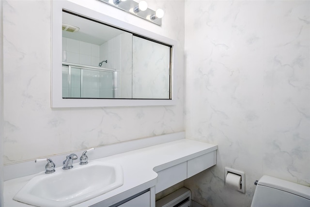 full bathroom featuring toilet, an enclosed shower, and vanity