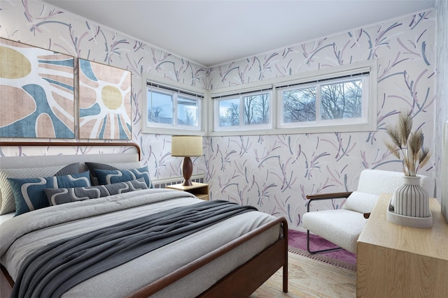 bedroom with wallpapered walls and multiple windows