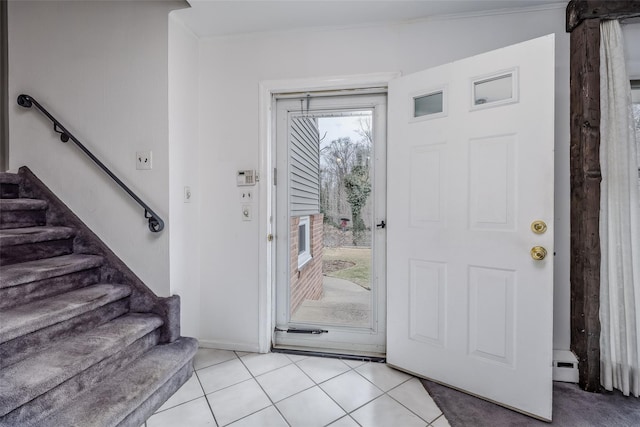 entryway with stairs and light tile patterned floors