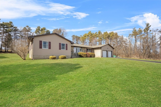 ranch-style house with a front yard, an attached garage, and driveway