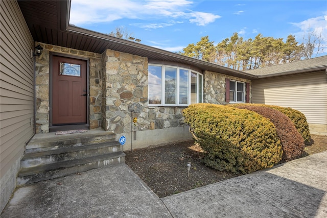 property entrance featuring stone siding