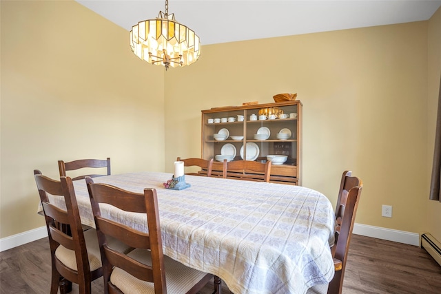 dining room featuring baseboards, an inviting chandelier, and wood finished floors