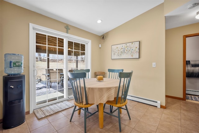 dining area featuring baseboards, lofted ceiling, baseboard heating, and light tile patterned flooring