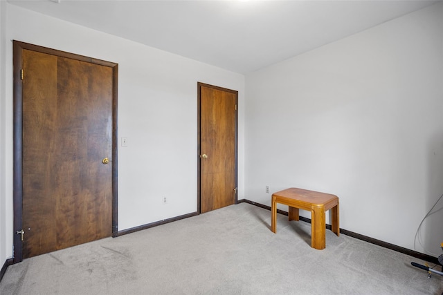 unfurnished bedroom with baseboards and carpet