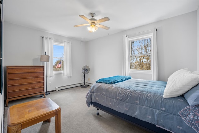 carpeted bedroom with baseboards, baseboard heating, and ceiling fan