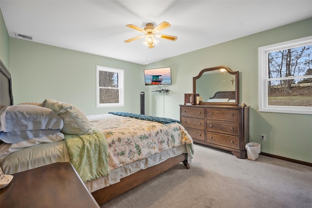 bedroom with visible vents, multiple windows, baseboards, and carpet flooring