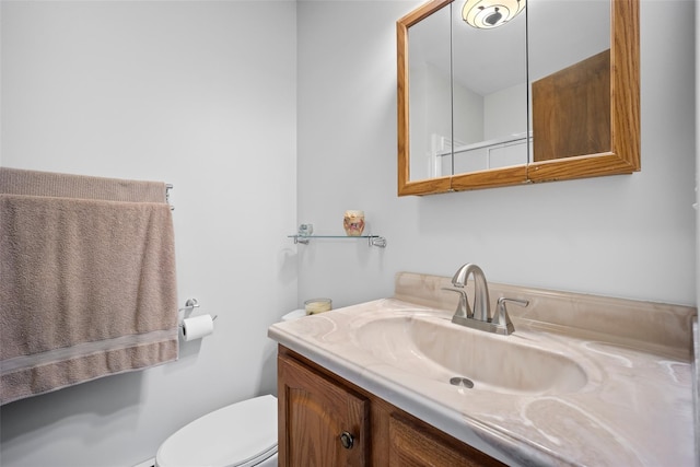 bathroom featuring vanity and toilet