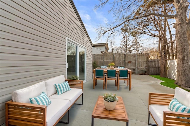 view of patio / terrace with outdoor dining area, fence, and an outdoor living space