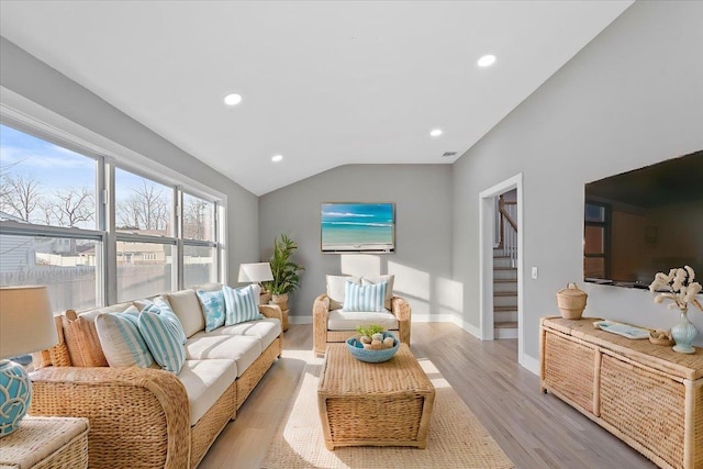 living room featuring light wood finished floors, recessed lighting, vaulted ceiling, baseboards, and stairs