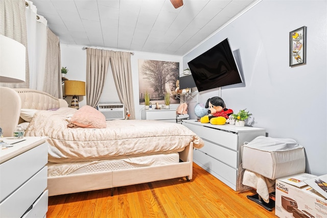 bedroom featuring cooling unit and light wood-style floors