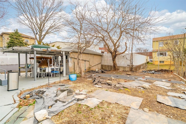 view of yard featuring a patio area, an outdoor structure, and a fenced backyard