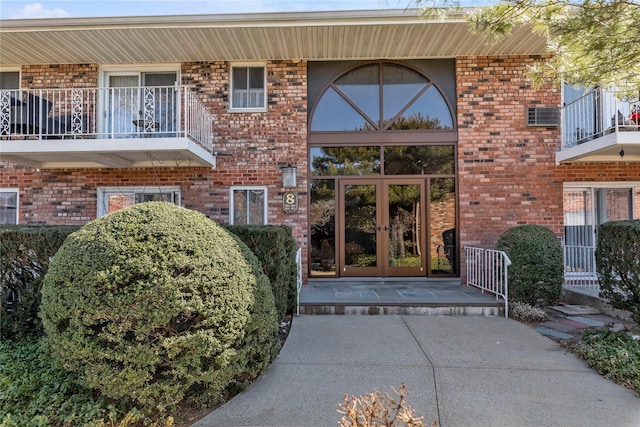 property entrance with french doors and brick siding