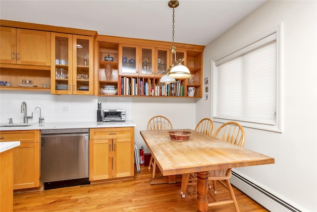 kitchen with a sink, stainless steel dishwasher, baseboard heating, open shelves, and pendant lighting