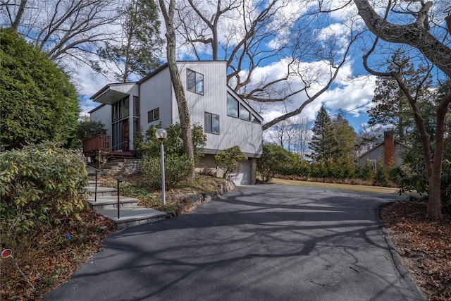 view of home's exterior featuring driveway and a garage