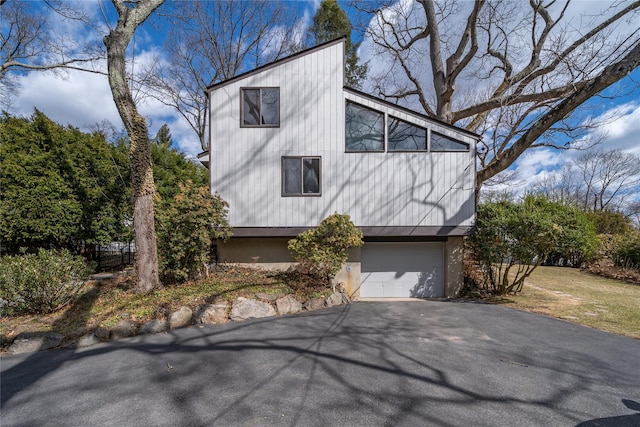 view of property exterior featuring an attached garage