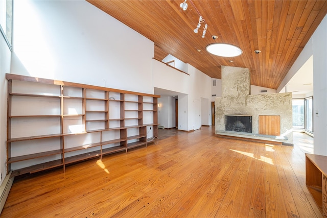 unfurnished living room featuring visible vents, high vaulted ceiling, wood ceiling, light wood-style floors, and a large fireplace