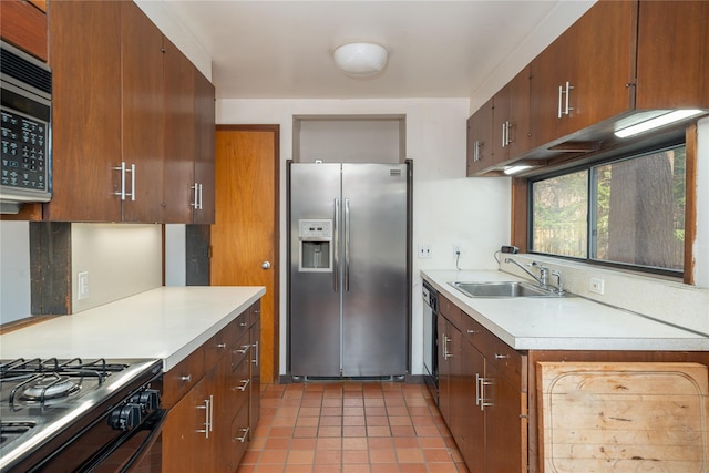 kitchen featuring stainless steel refrigerator with ice dispenser, a sink, light tile patterned flooring, light countertops, and dishwasher