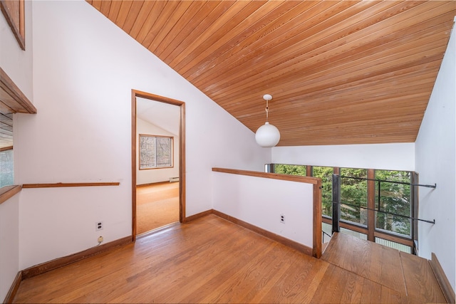 empty room featuring wooden ceiling, high vaulted ceiling, baseboards, and wood finished floors