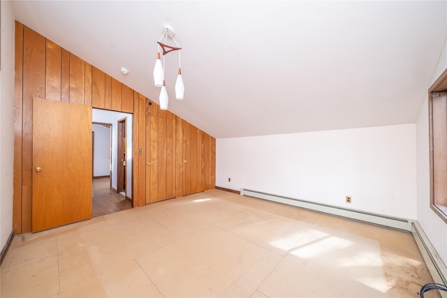 bonus room featuring lofted ceiling, baseboard heating, and wood walls