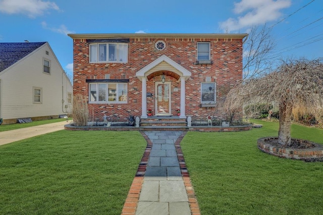 view of front of property featuring a front lawn and brick siding