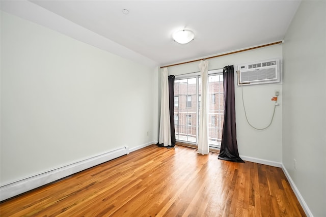 41-38 66th St, Woodside, NY 11377 - spare room featuring a baseboard heating unit, an AC wall unit, light wood finished floors, and baseboards