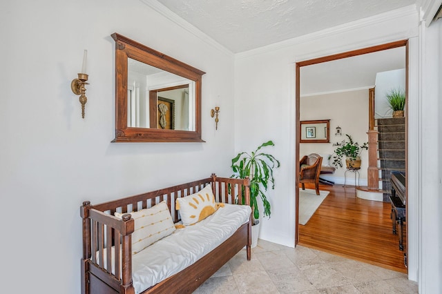 living area with a textured ceiling, stairway, baseboards, and crown molding