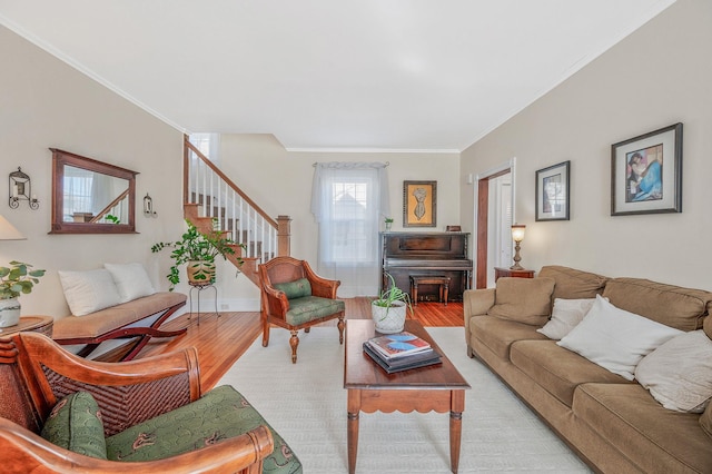 living room featuring stairs, crown molding, and wood finished floors