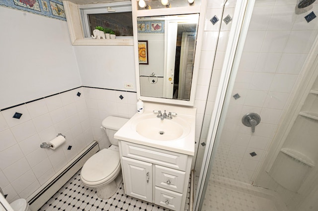 full bath featuring tile walls, a baseboard radiator, toilet, a shower stall, and vanity