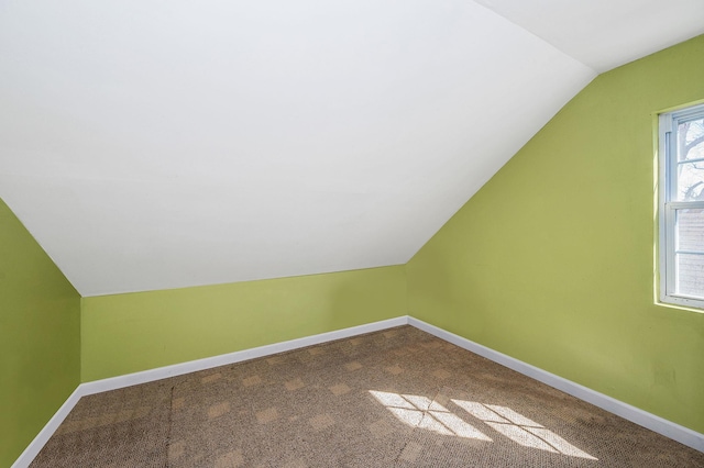 bonus room featuring carpet floors, vaulted ceiling, and baseboards