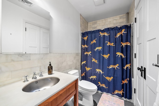 bathroom featuring tile walls, visible vents, a shower with shower curtain, toilet, and vanity