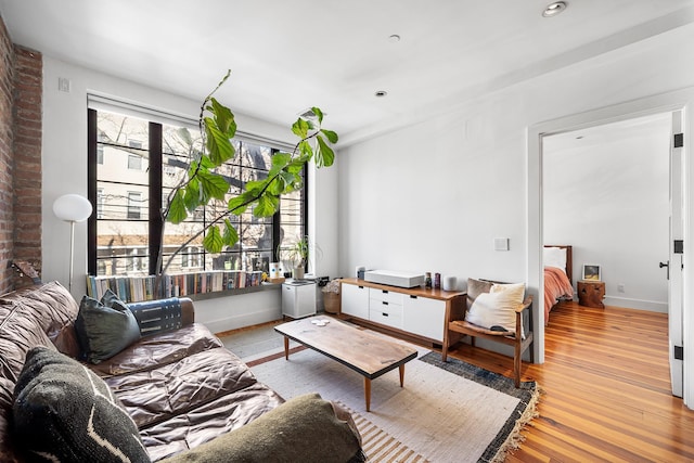 living room featuring recessed lighting, wood finished floors, and baseboards