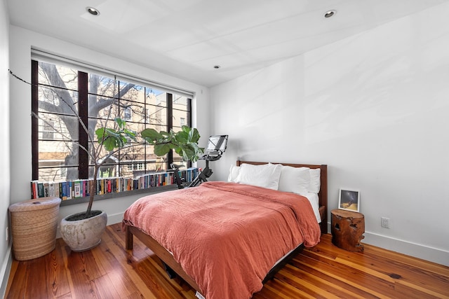 bedroom with wood-type flooring, baseboards, and recessed lighting