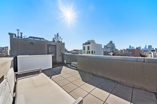 view of patio featuring a balcony and a city view