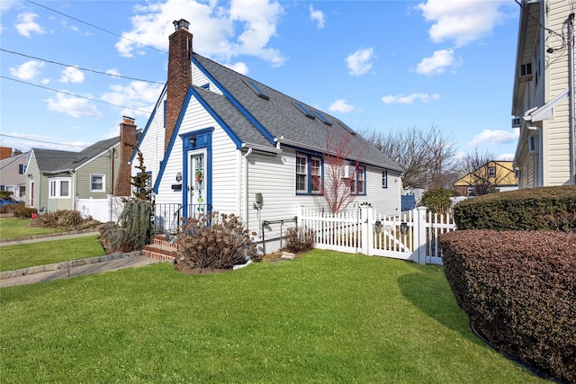 view of home's exterior with a shingled roof, fence, a yard, a gate, and a chimney