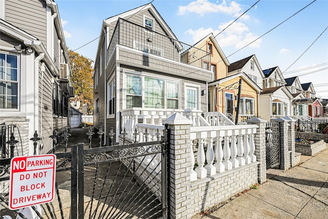 view of front of home with a fenced front yard and a gate