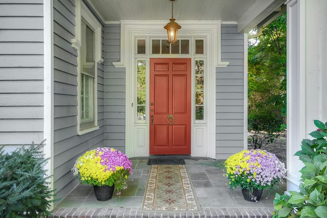 view of exterior entry with covered porch