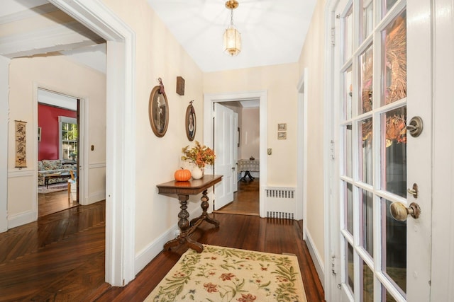 hall featuring baseboards, radiator heating unit, and parquet flooring