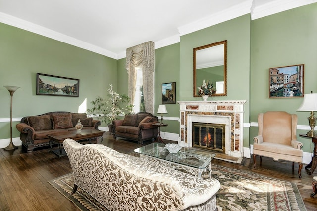 living area featuring ornamental molding, baseboards, hardwood / wood-style floors, and a premium fireplace