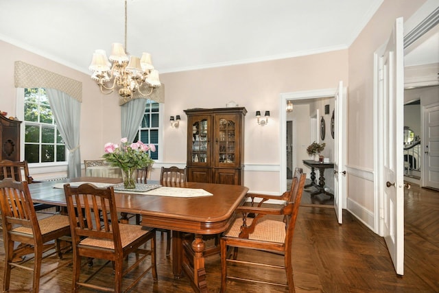 dining space featuring ornamental molding and a chandelier