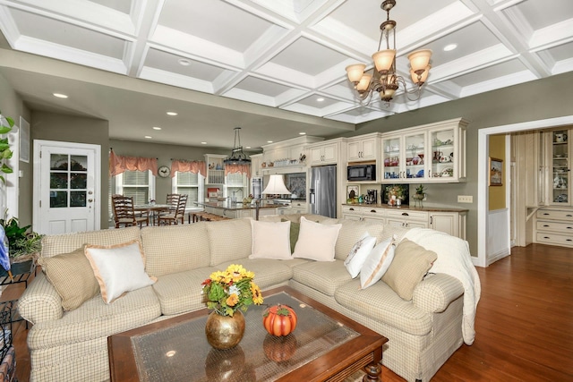 living area with a chandelier, dark wood-style flooring, coffered ceiling, and beam ceiling