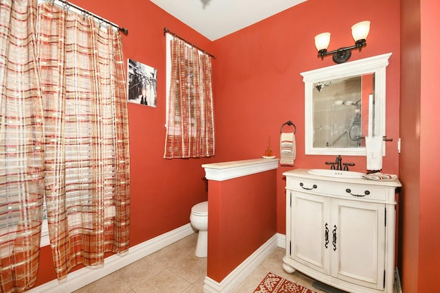 bathroom featuring curtained shower, tile patterned flooring, toilet, vanity, and baseboards