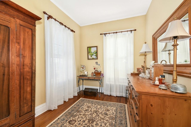 interior space with wood finished floors and baseboards