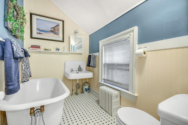 bathroom with lofted ceiling, radiator heating unit, and toilet